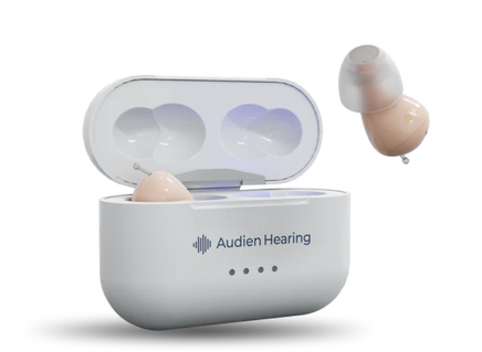 Hearing aid in a white charging case with 'Audien Hearing' branding on a white background